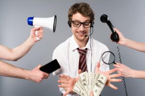 A man wearing a headset holds bundles of money in his hands, symbolizing success in business or finance.