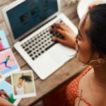 A woman focused on her laptop